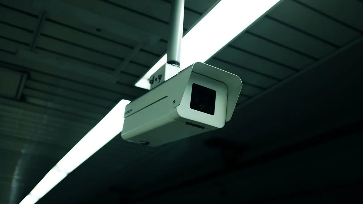 Security camera mounted under the roof of a building