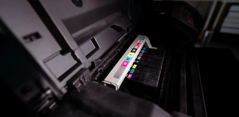 Printer opened up showing its ink cartridges and print carriage inside